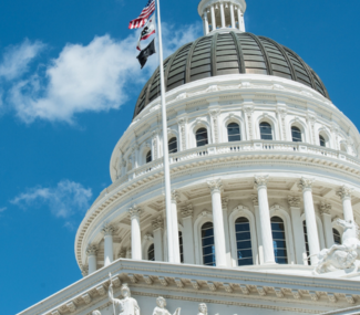 capitol dome CA and US flags